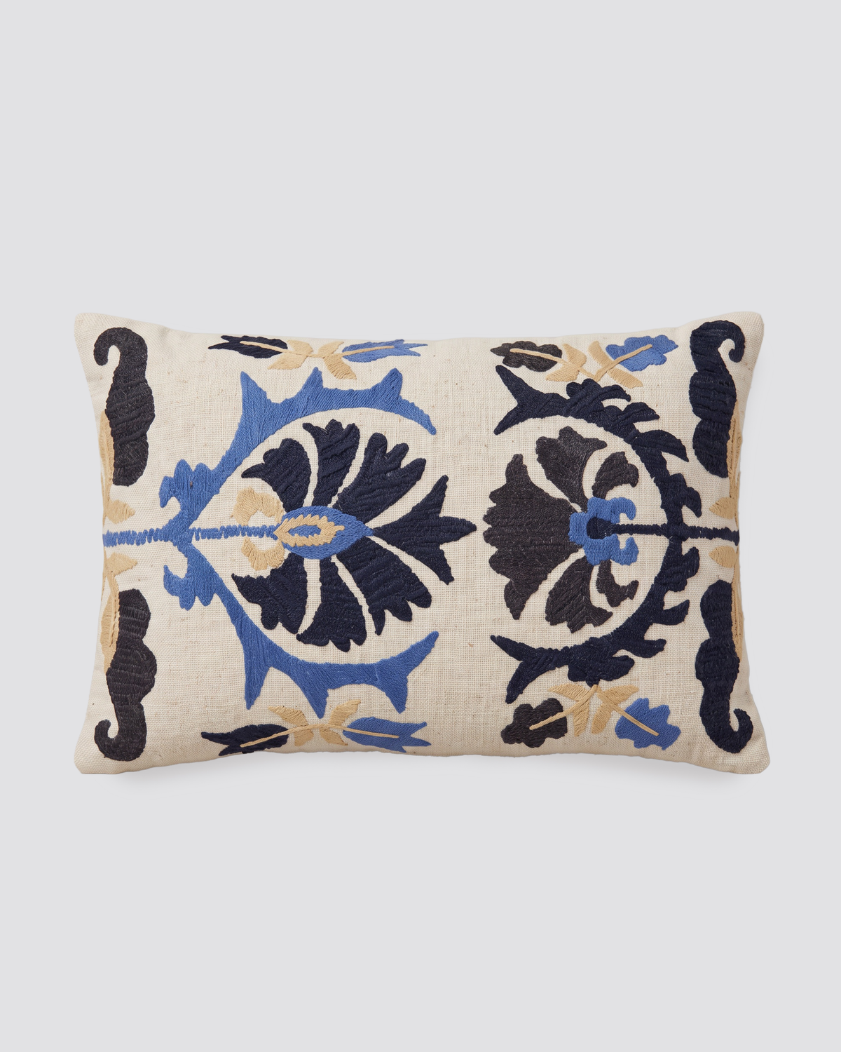 Blue Dori slub pillow cover with bold navy and blue embroidered motifs on cream