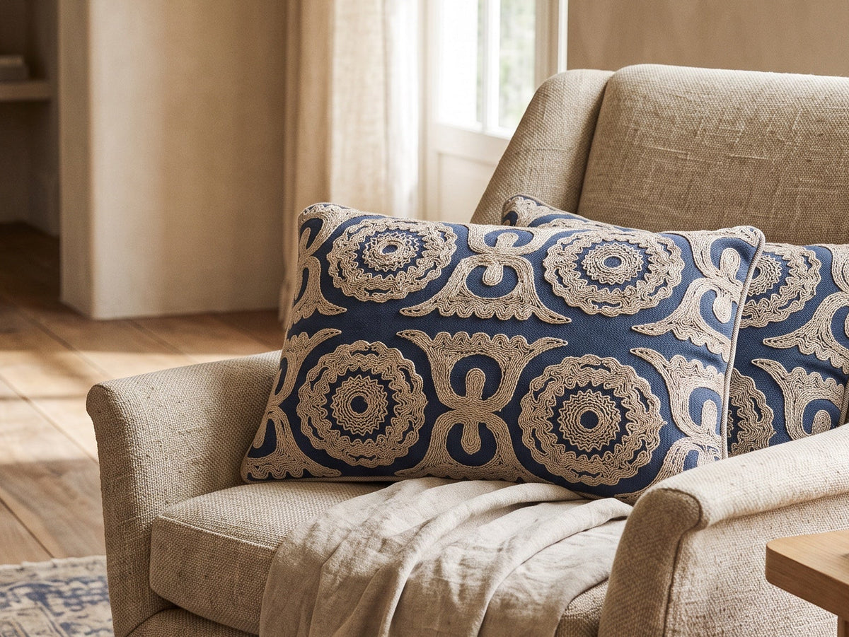 Blue Dori pillow on a cream armchair in a sunlit room