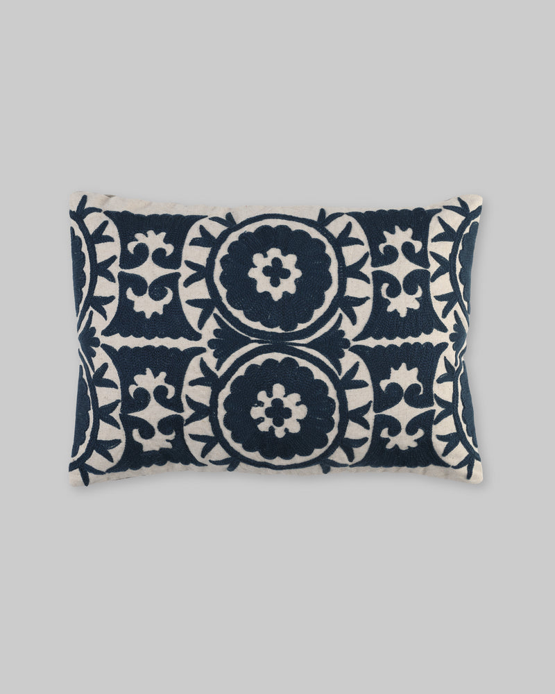 Rectangular pillow cover with navy blue ari-embroidered medallions on ivory