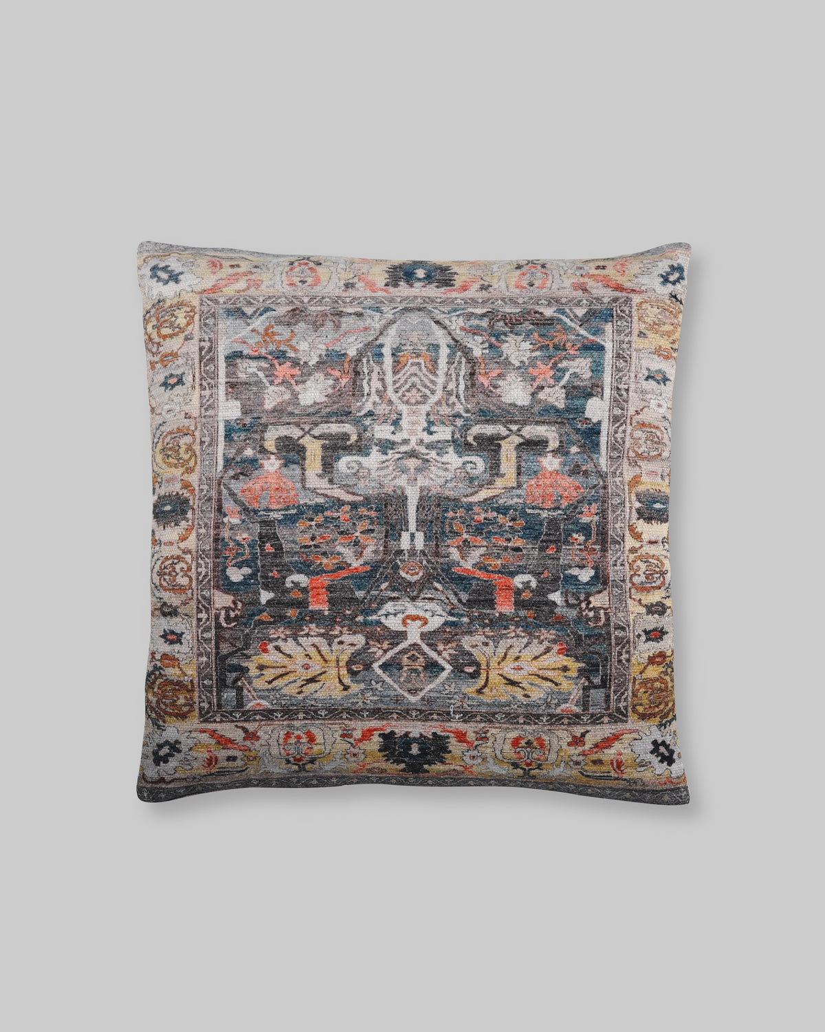 Black slub cotton cushion cover with a faded rug-style print in charcoal, rust and blue