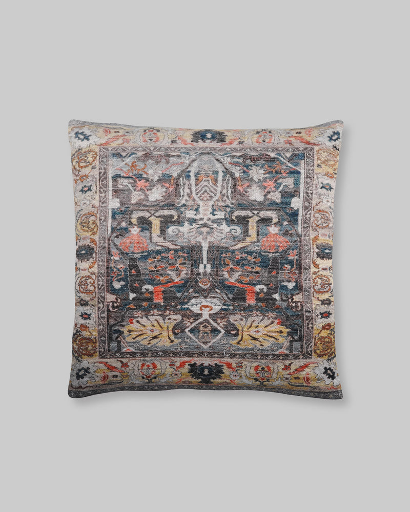 Black slub cotton cushion cover with a faded rug-style print in charcoal, rust and blue