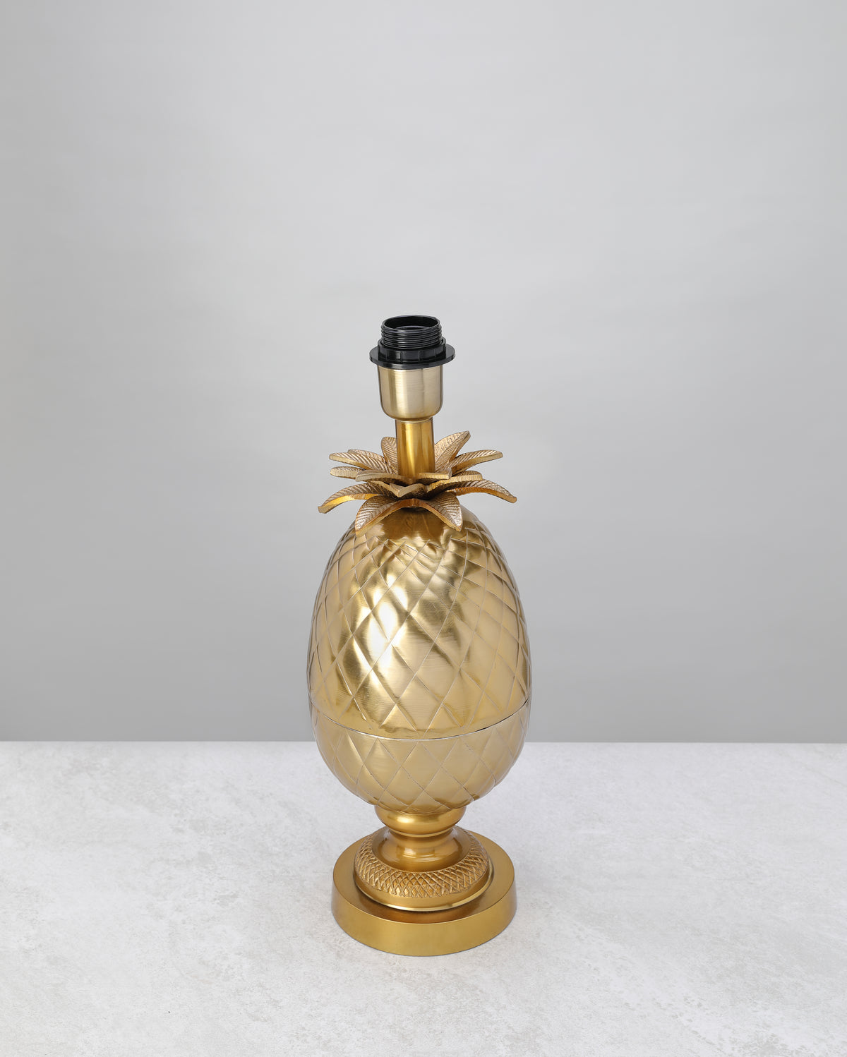 Antique brass pineapple table lamp base with leaf crown, shown without a shade