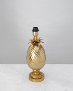 Antique brass pineapple table lamp base with leaf crown, shown without a shade