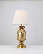 Antique brass pineapple lamp base styled with a linen shade (shade not included)