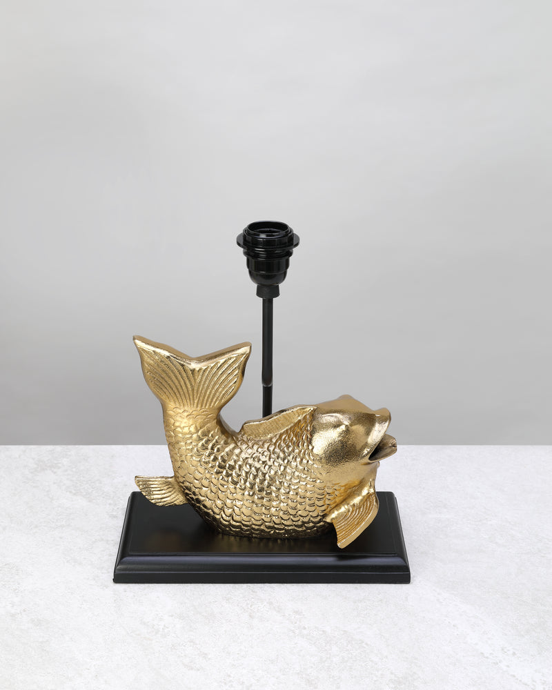 Gilded koi fish table lamp base on a black stand, shown without a shade