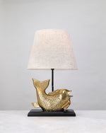 Gilded koi form lamp base styled with a linen shade (shade not included)