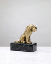 Gold lion figure seated on a black marble-finish base, on white