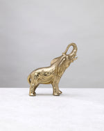 Petite gold elephant figure from the other side, trunk curled upward