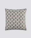 Blue overlock cushion cover with a small blue block-print motif on cream, front view