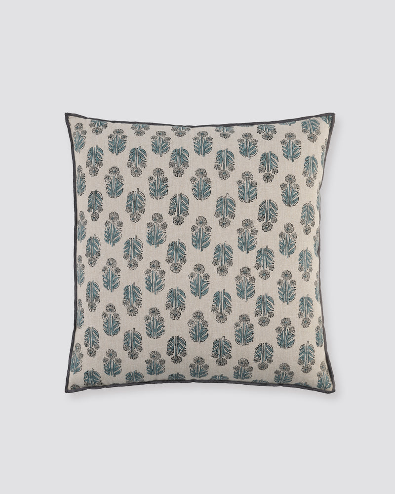 Blue overlock cushion cover with a small blue block-print motif on cream, front view
