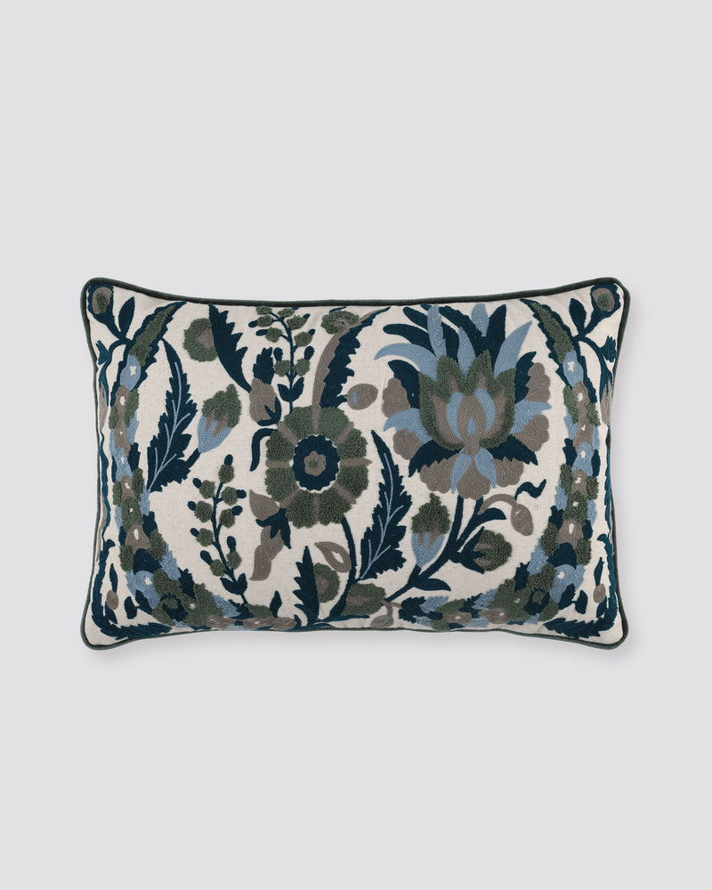 Linen pillow cover with tufted navy, teal and grey floral motifs and a dark piped edge