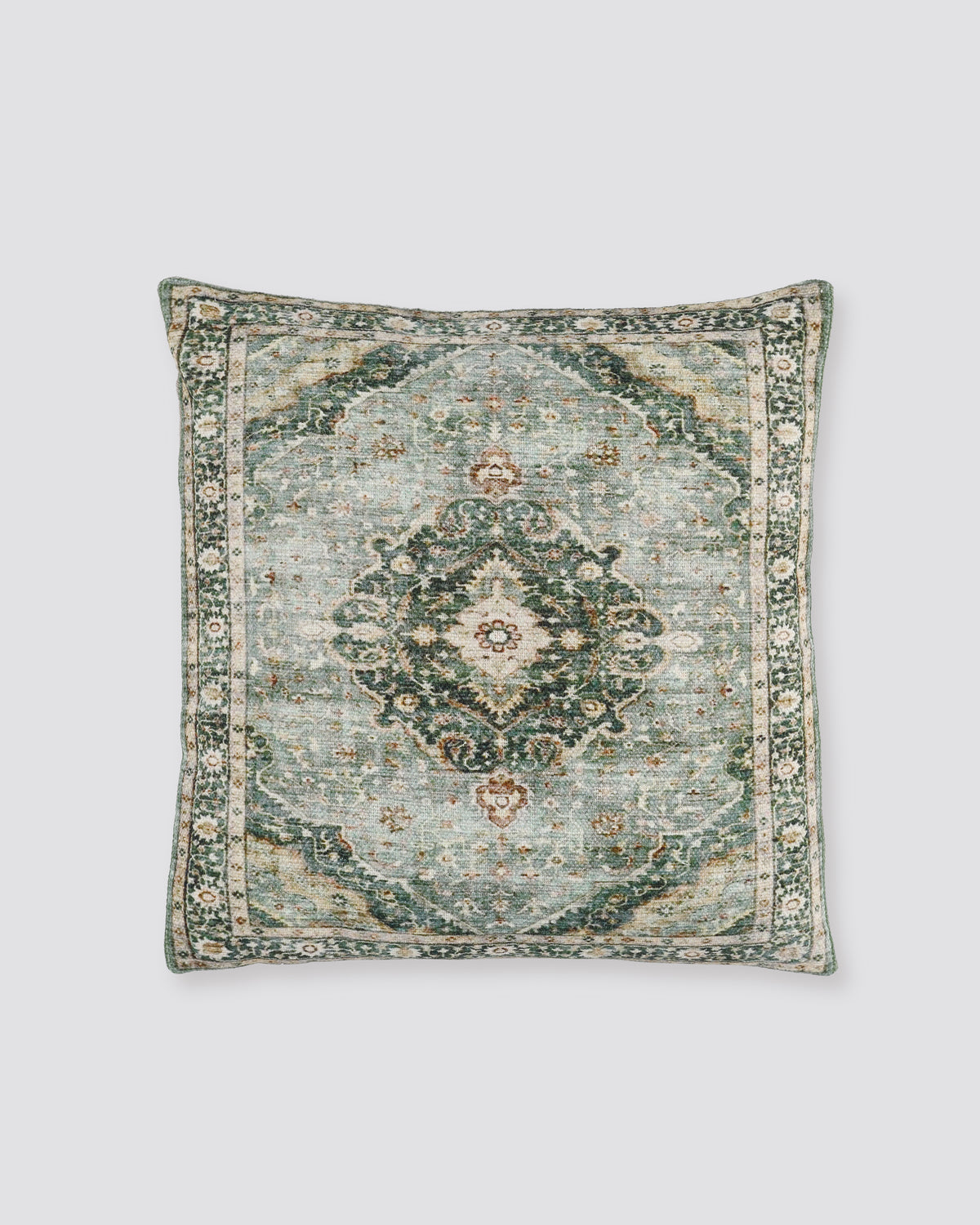 Sage green slub cotton cushion cover with a faded medallion print, front view