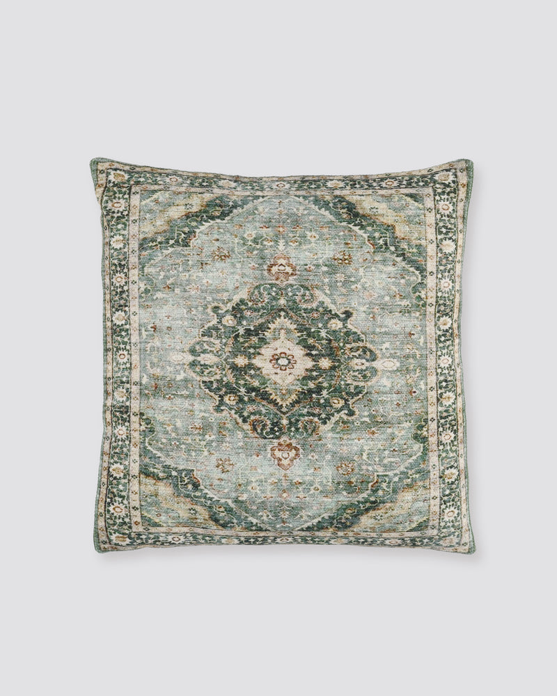 Sage green slub cotton cushion cover with a faded medallion print, front view