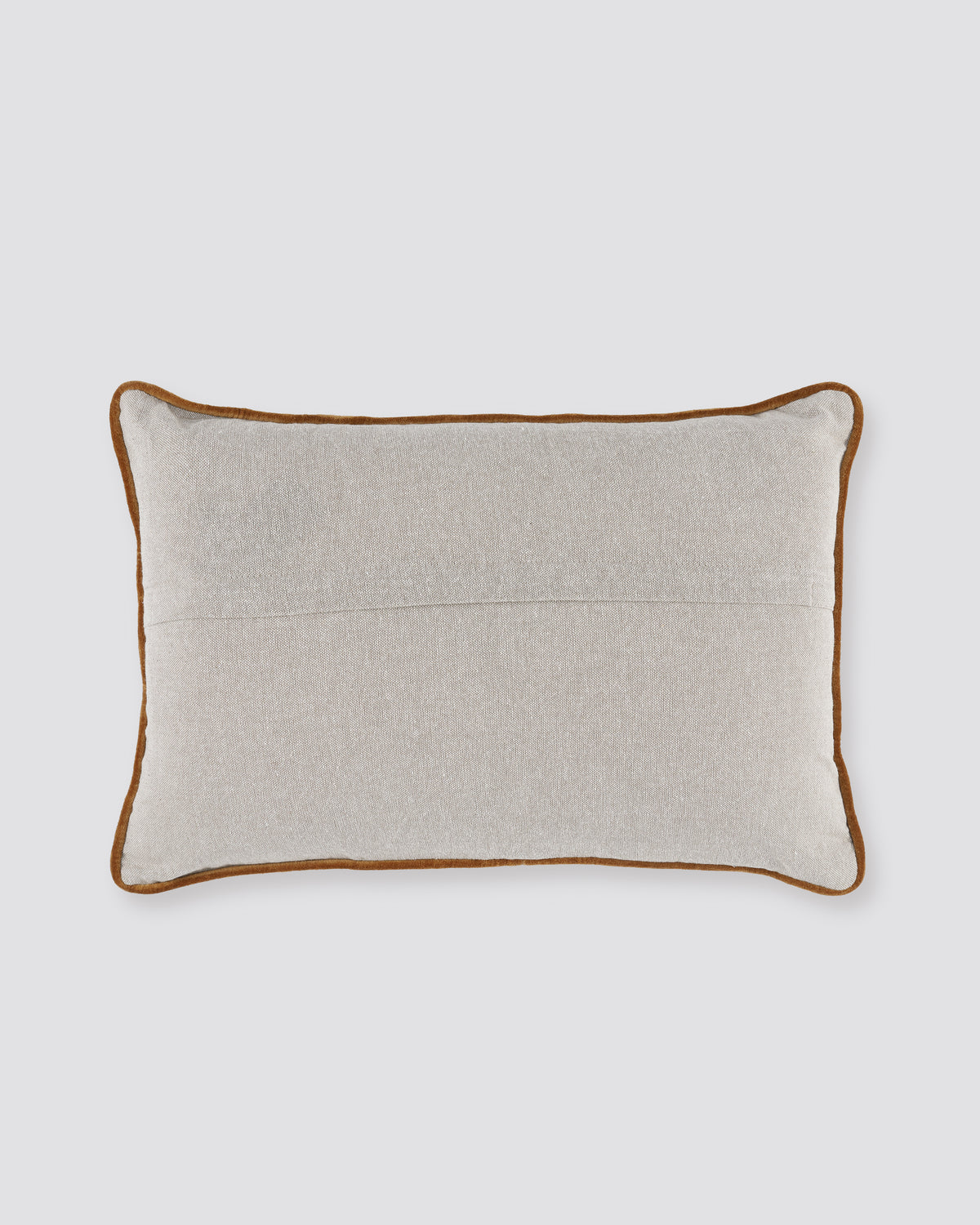 Plain back of the layered dori pillow cover with rust piping