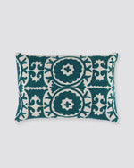 Rectangular pillow cover with teal ari-embroidered medallions on ivory