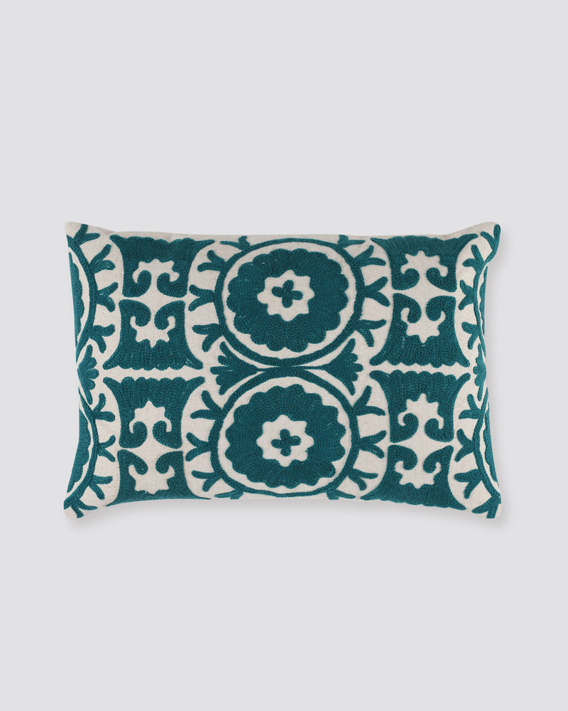 Rectangular pillow cover with teal ari-embroidered medallions on ivory