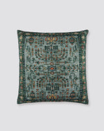 Green slub cotton cushion cover with a rug-style print in green, rust and cream