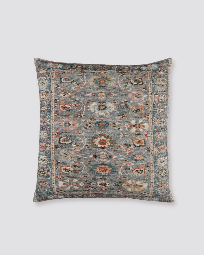 Grey slub cotton cushion cover with a rug-style floral print in grey, rust and cream