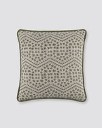 Green piped cushion cover with a zigzag block print on cream and a green piped edge