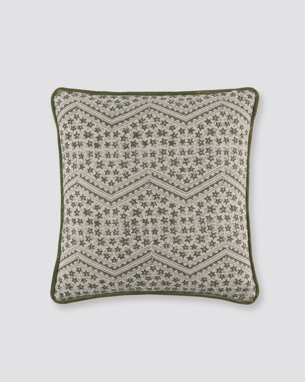 Green piped cushion cover with a zigzag block print on cream and a green piped edge
