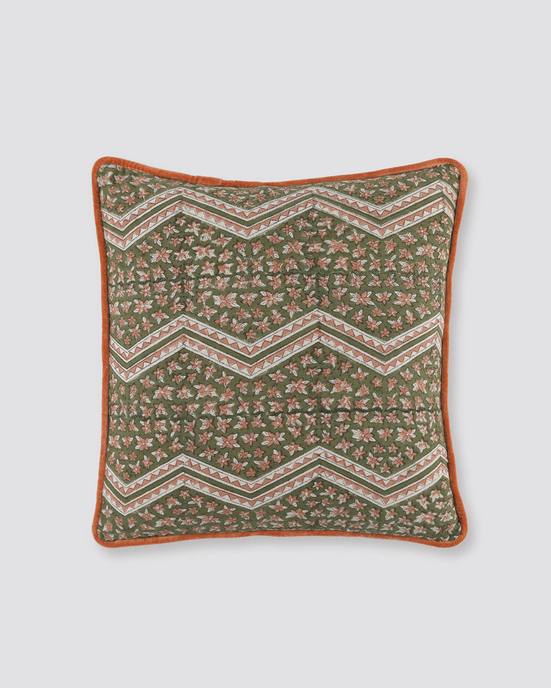 Orange piped cushion cover with a green zigzag block print and rust piping, front view