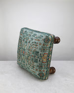 Green print square foot stool, angled view