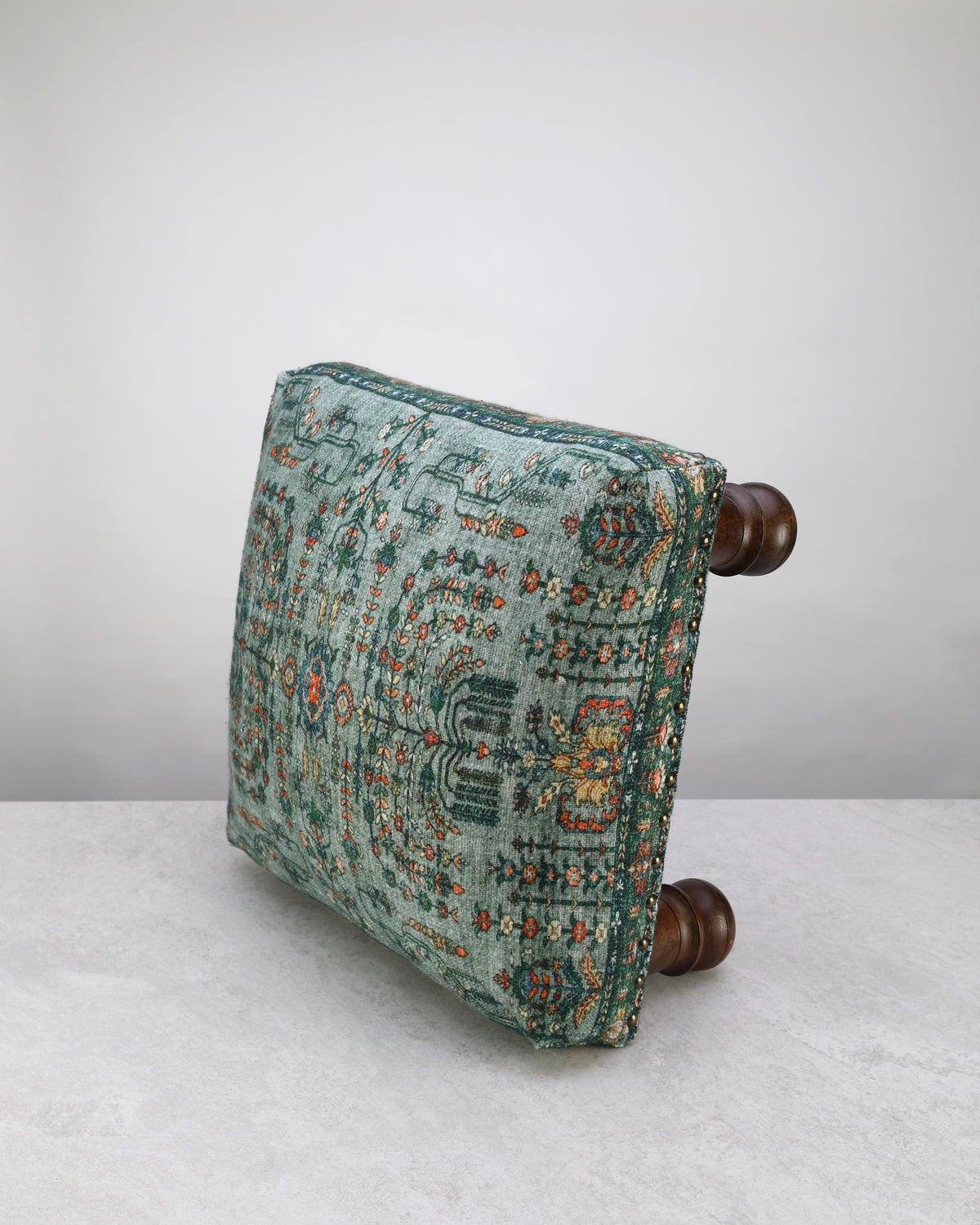 Green print square foot stool, angled view