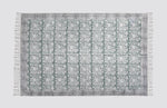Green and grey block print dhurrie rug laid flat with a geometric tile pattern