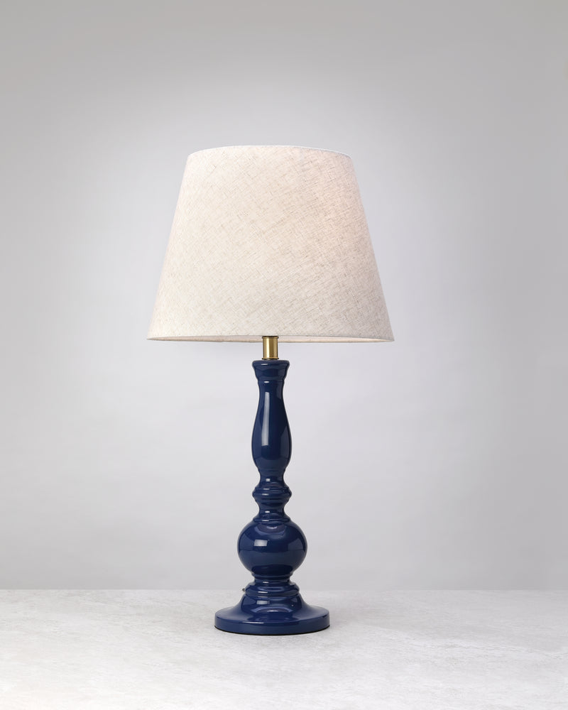Deep blue Dusk mango wood table lamp with a glossy turned base and linen shade, on white