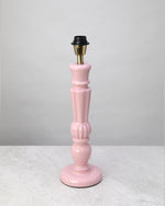 Soft pink turned mango wood lamp base shown without its shade