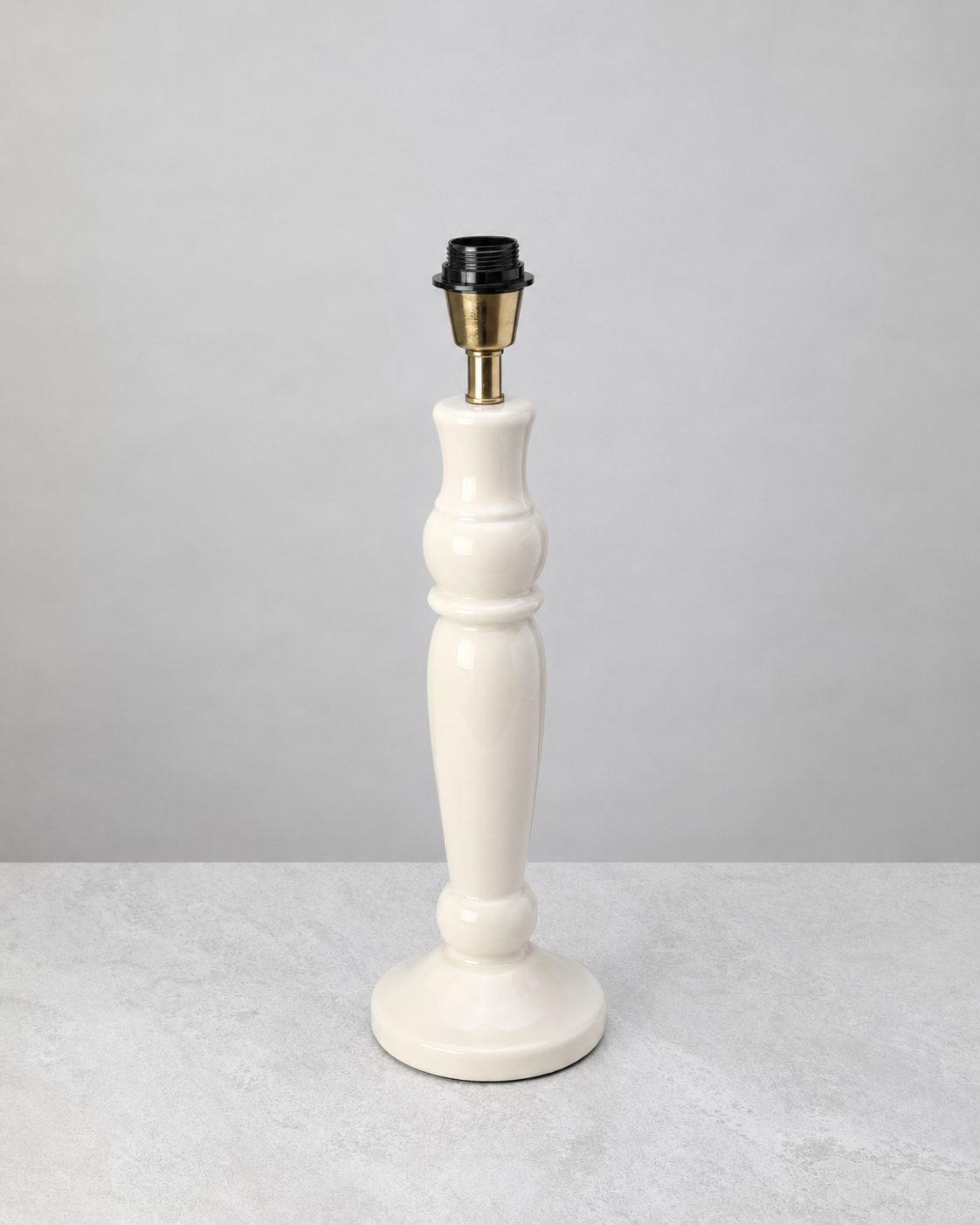 Warm white turned mango wood lamp base shown without its shade