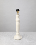 Warm white turned mango wood lamp base shown without its shade