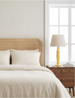 Yellow Sunlit mango wood lamp on a bedside table