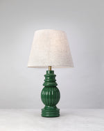 Sage green Hearth mango wood table lamp with a ribbed glossy base and linen shade, on white