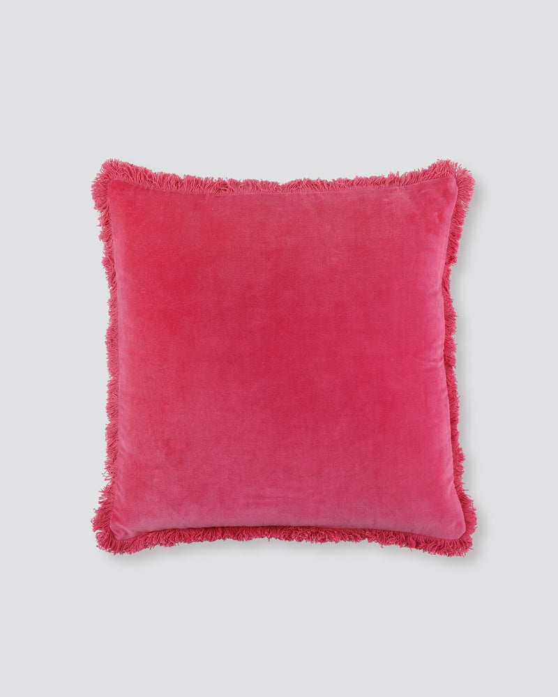 Pink square velvet cushion cover with a fringed edge on all four sides, front view