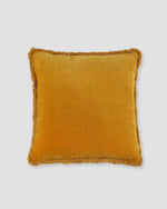 Mustard yellow square velvet cushion cover with a fringed edge, front view