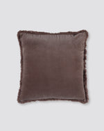 Dusty pink square velvet cushion cover with a fringed edge on all four sides, front view