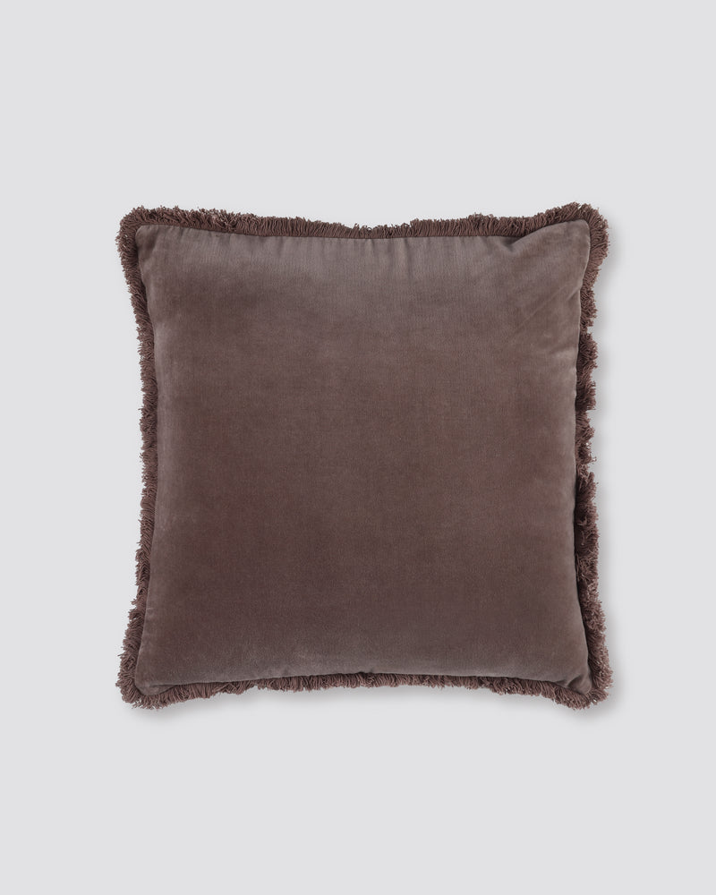 Dusty pink square velvet cushion cover with a fringed edge on all four sides, front view