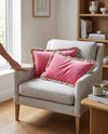 Pink frill velvet cushion covers on a white armchair