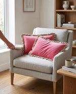 Pink frill velvet cushion covers on a white armchair