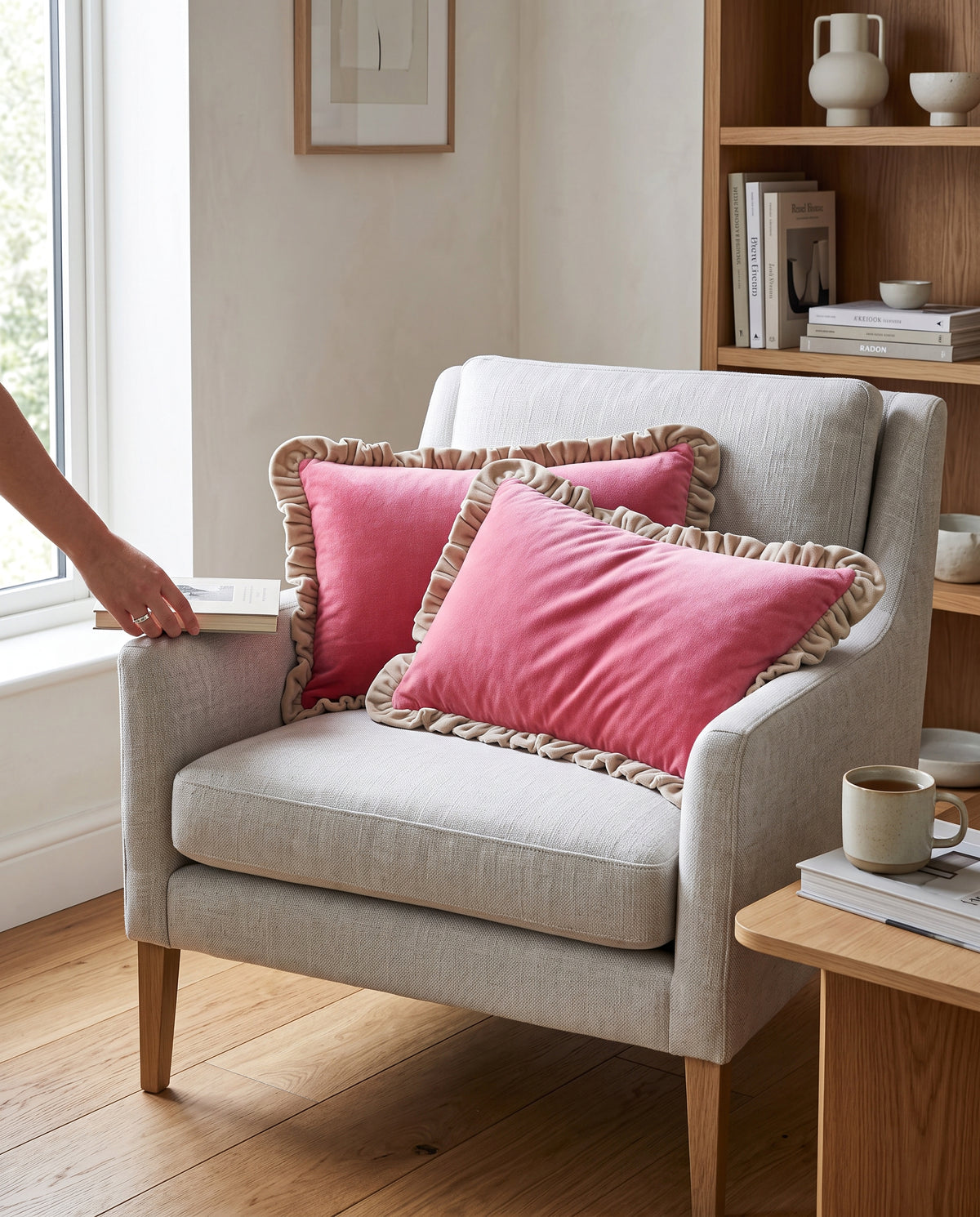 Pink frill velvet cushion covers on a white armchair