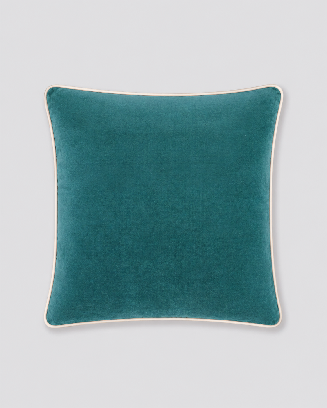 Teal velvet cushion cover with cream piping around the edge, front view