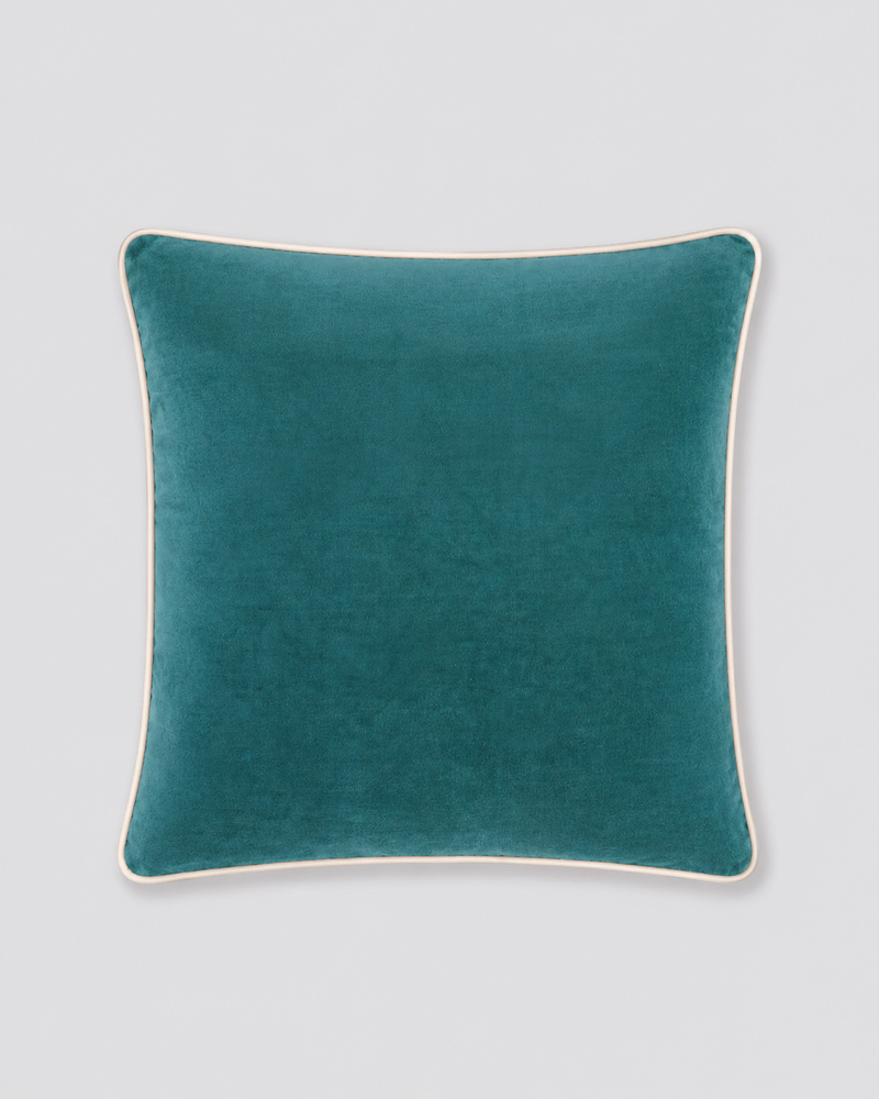 Teal velvet cushion cover with cream piping around the edge, front view