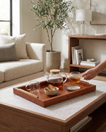 Large tan slim faux leather tray on a coffee table with a teapot and cups, a hand serving