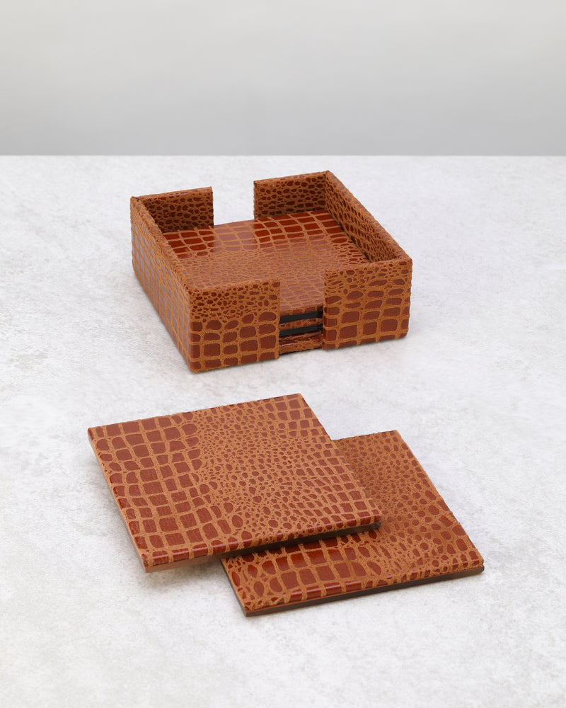 Tan croc-textured faux leather coaster set with its holder, coasters laid in front