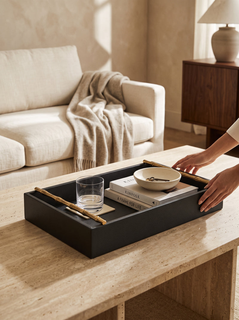 Hands setting the large olive green faux leather tray on a coffee table