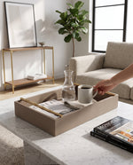 Large pea green faux leather tray on a marble coffee table with a carafe, cup and book