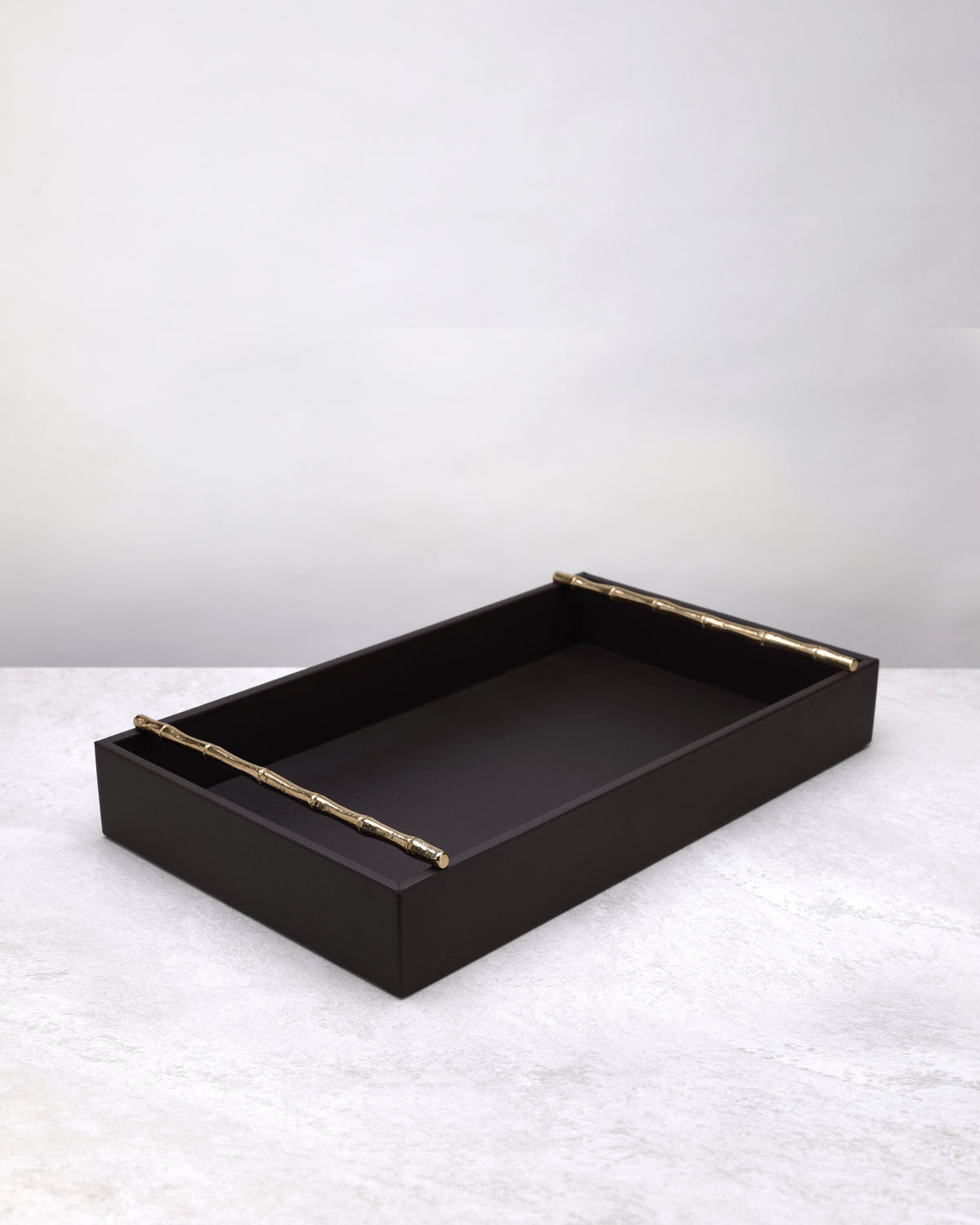 Small cherry brown faux leather tray with brass handles, on white