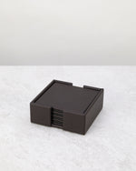 Cherry brown faux leather coasters stacked in their square holder
