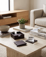 Cherry faux leather coaster set on a living room coffee table